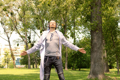 Portrait of man standing by plants in park