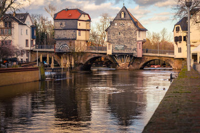 Footbridge over river against sky