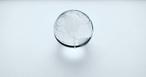 Close-up of bubbles in glass against white background