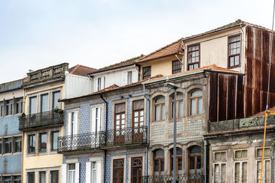 Low angle view of residential building against cloudy sky