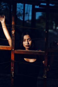 Portrait of young woman standing in abandoned house