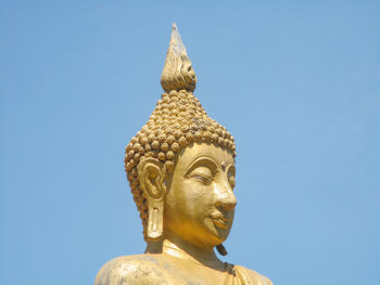 Low angle view of statue against blue sky