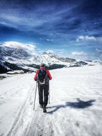 Full length of person on snowcapped mountain against sky