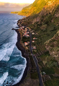 High angle view of sea shore against sky during sunset