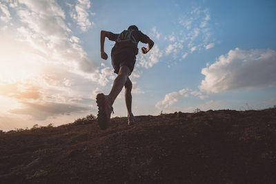 Low angle view of man standing on field against sky