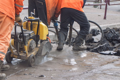 Low section of men working at construction site