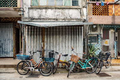 Bicycles parked on street against buildings