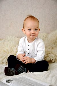 Portrait of cute boy sitting at home