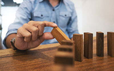 Close-up of hand holding toy on table