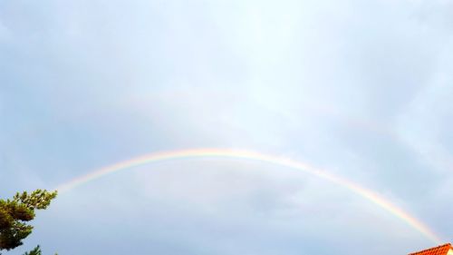 Low angle view of rainbow against sky