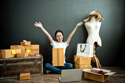 Portrait of smiling young woman standing on table