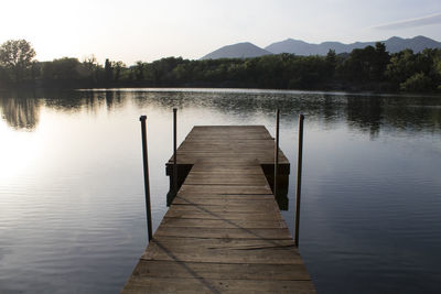 Pier over lake against sky