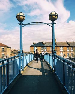 People walking on street against buildings