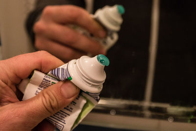 Close-up of hand holding bottle