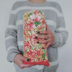 Midsection of woman holding bag of popcorn