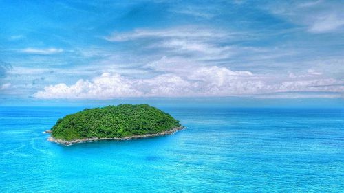 Scenic view of island amidst sea against sky