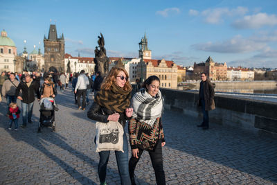 Group of people walking in front of buildings