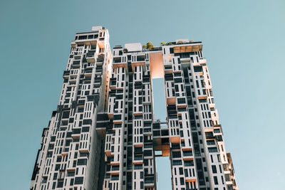 Low angle view of modern buildings against clear blue sky