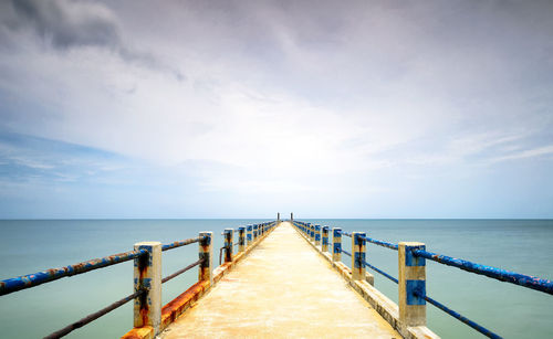 Pier over sea against sky