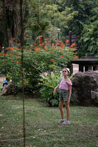 Portrait of young woman standing on field