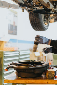 Cropped image of mechanic working in garage