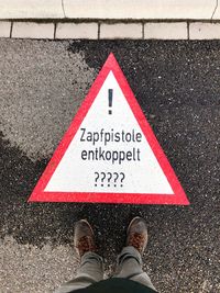 Low section of man by road sign