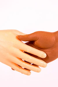 Close-up of hands over white background