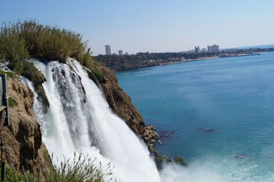 Scenic view of waterfall and sea