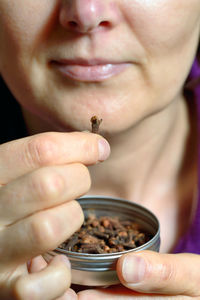 Close-up of woman eating hands