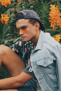 Young man with sunglasses on flower