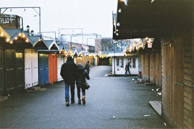 Rear view of woman on road in city