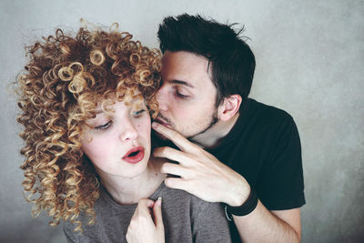 Portrait of young couple kissing