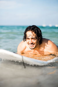 Portrait of shirtless man in sea