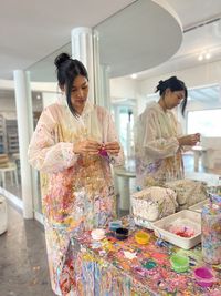 Portrait of young woman standing at home