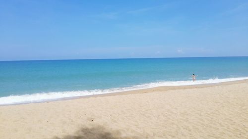 Scenic view of beach against clear blue sky