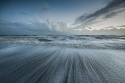 View of calm sea against cloudy sky