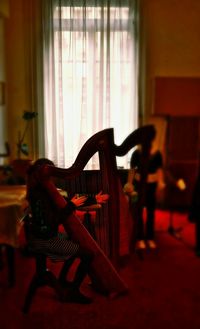 Young woman sitting on chair at home