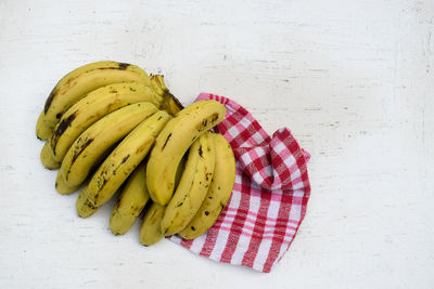 High angle view of fruit on table against white background