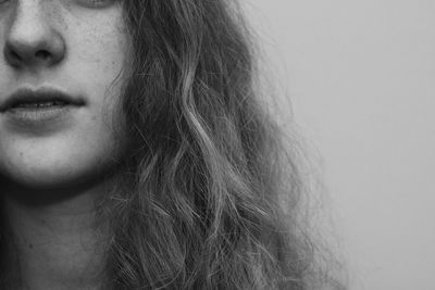Close-up portrait of young woman over white background