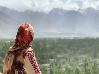 Rear view of woman looking at mountains