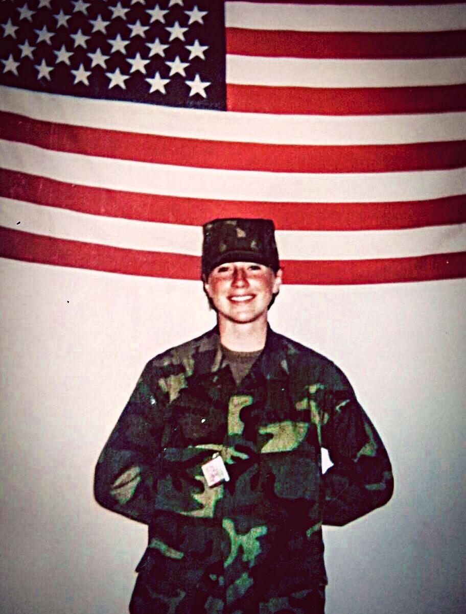 PORTRAIT OF SMILING YOUNG MAN STANDING AGAINST FLAG