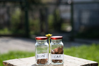 Close-up of coins in jars on table