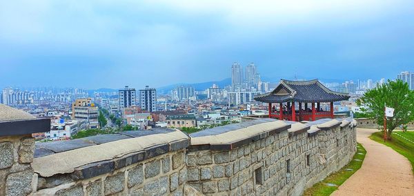 Panoramic view of buildings in city against sky