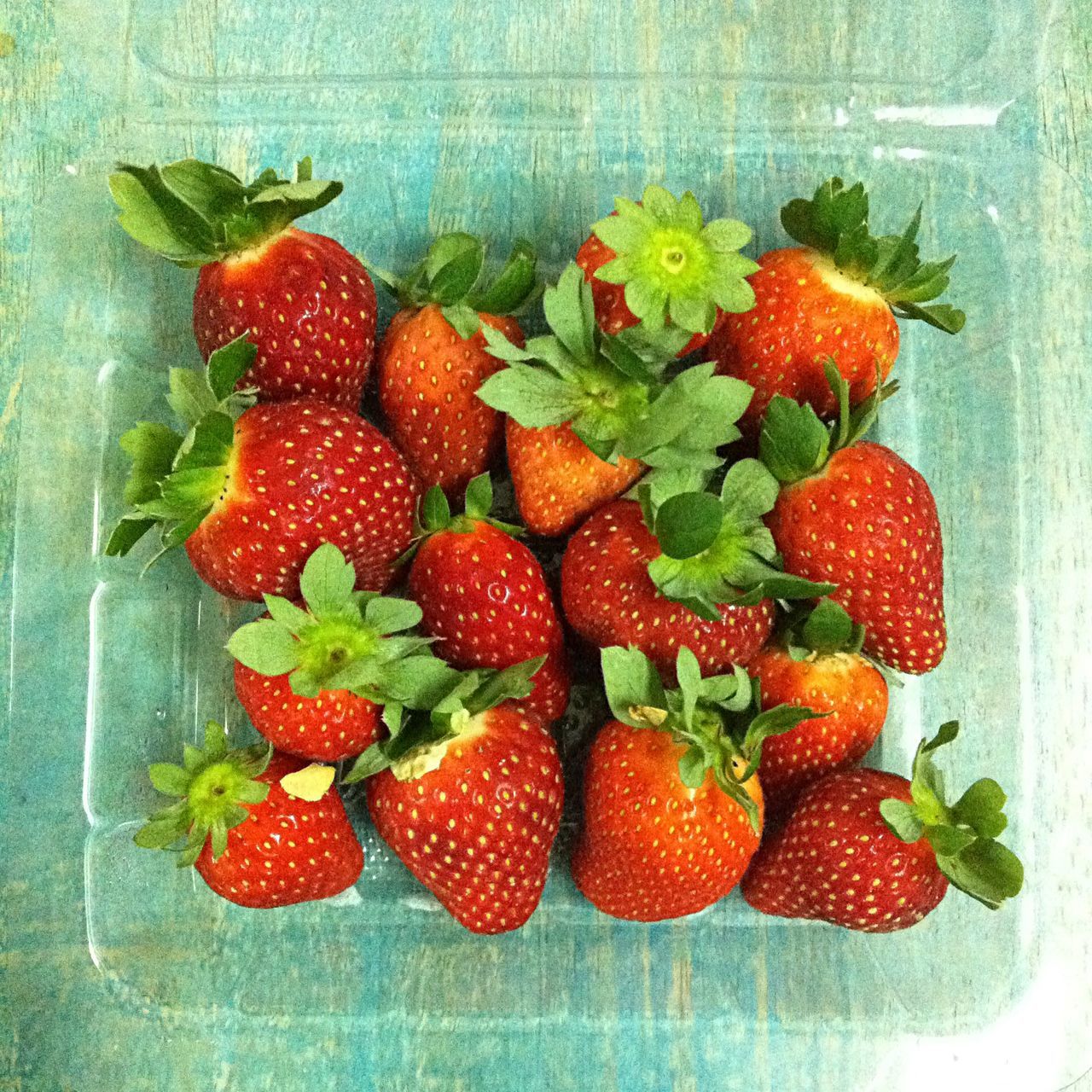 food and drink, freshness, food, healthy eating, fruit, indoors, red, strawberry, still life, table, high angle view, leaf, close-up, organic, directly above, ripe, no people, berry fruit, vegetable, green color