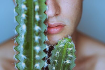 Close-up midsection of woman with cactuses