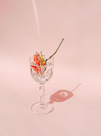 Close-up of wine glass on table against white background