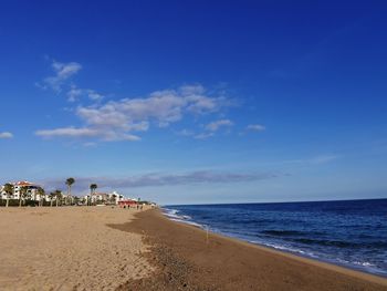 Scenic view of beach against blue sky