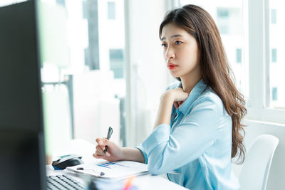 Portrait of young businesswoman working at clinic