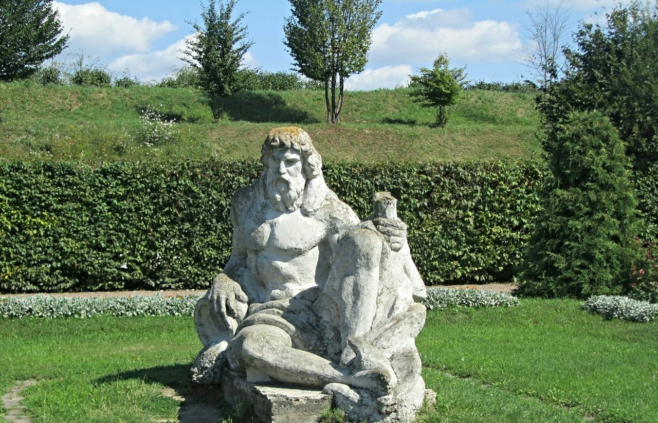 sculpture, statue, grass, tree, human representation, art and craft, sky, art, green color, creativity, stone material, park - man made space, stone, nature, tranquility, stone - object, rock - object, growth, day