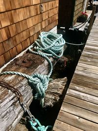 Close-up of rope tied on wooden pier